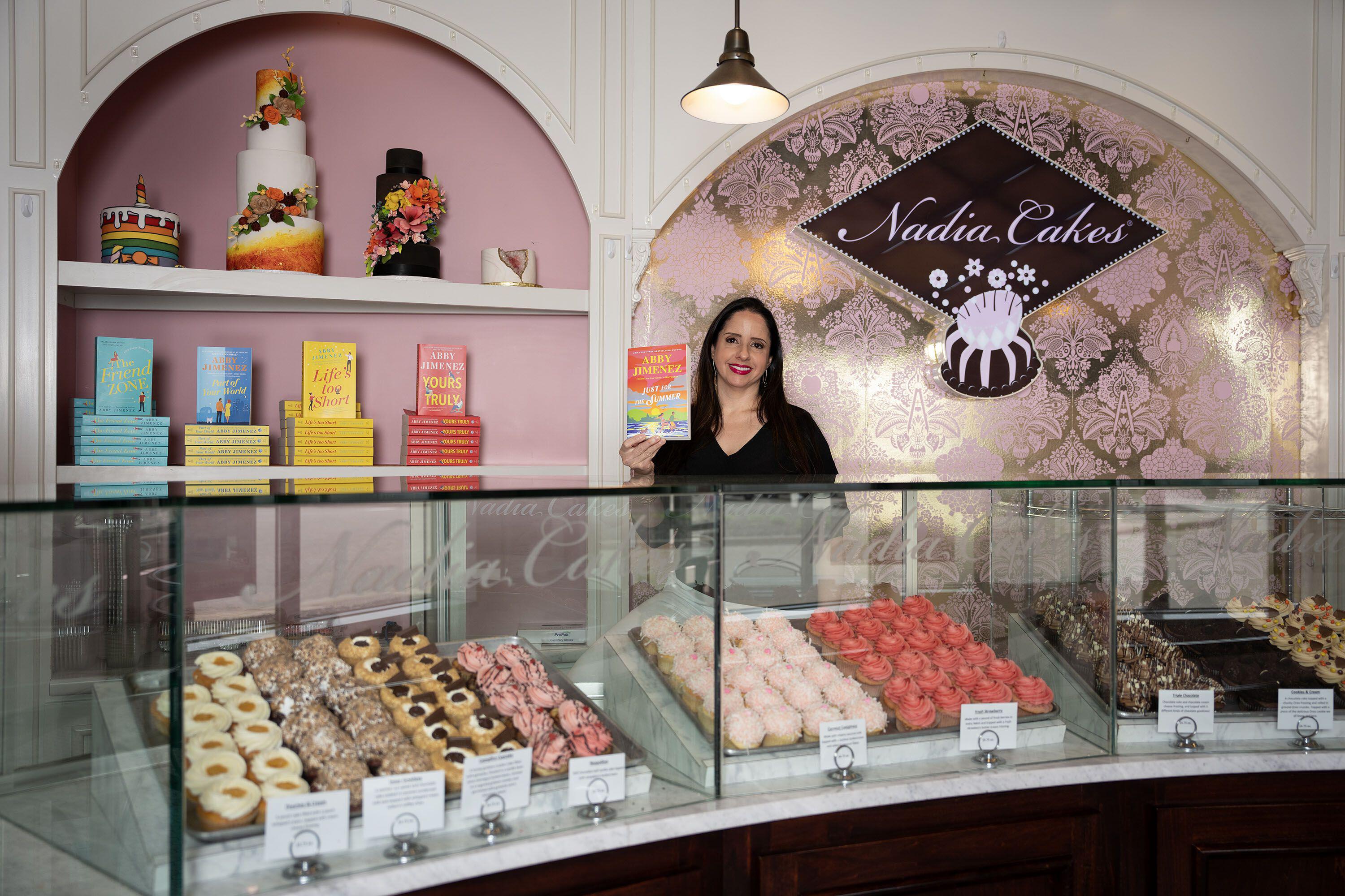 Abby Jimenez stands in a high-end bakery