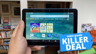 Amazon Kindle Fire Tablet held in front of living room