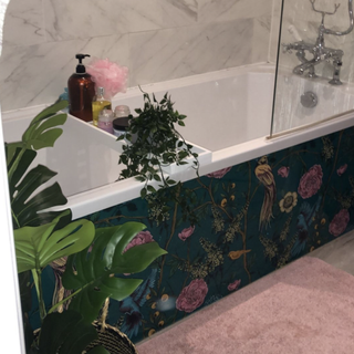 Floral patterned bath panel on white bath tub
