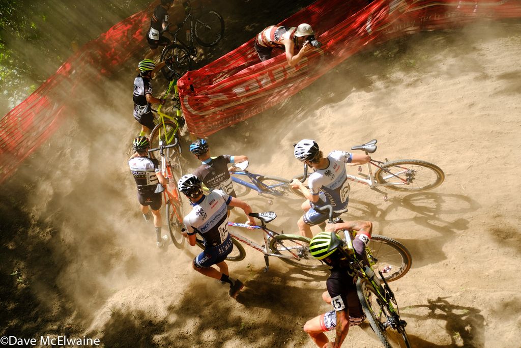 Riders bunch up on the dusty downhill switchback