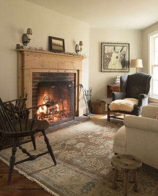 living room with lit fire in 1700s New England farmhouse