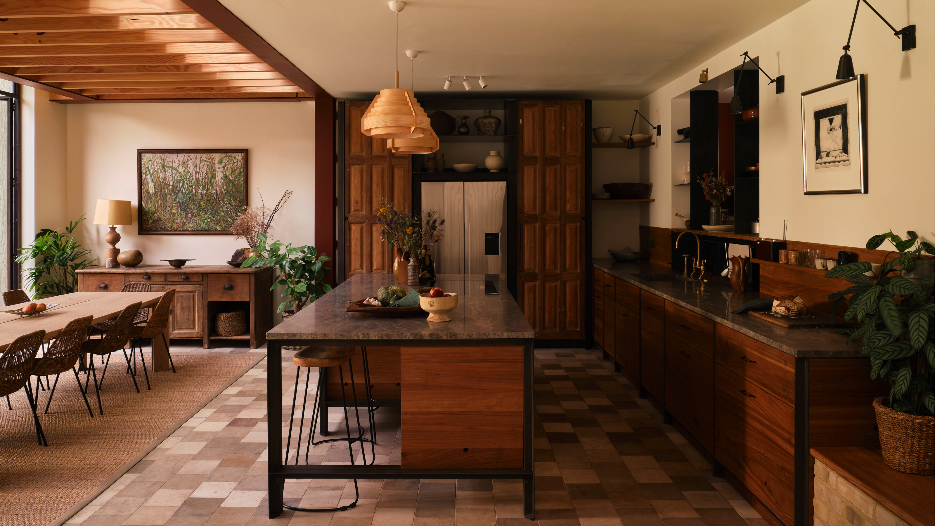 a warm, wooden kitchen with tiled floor and an open plan layout