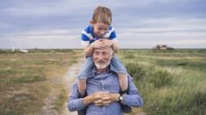 Man carrying young boy on his shoulders