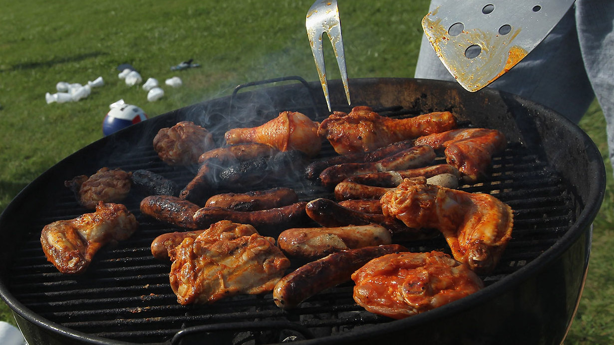 Chicken wings and sausages on a BBQ