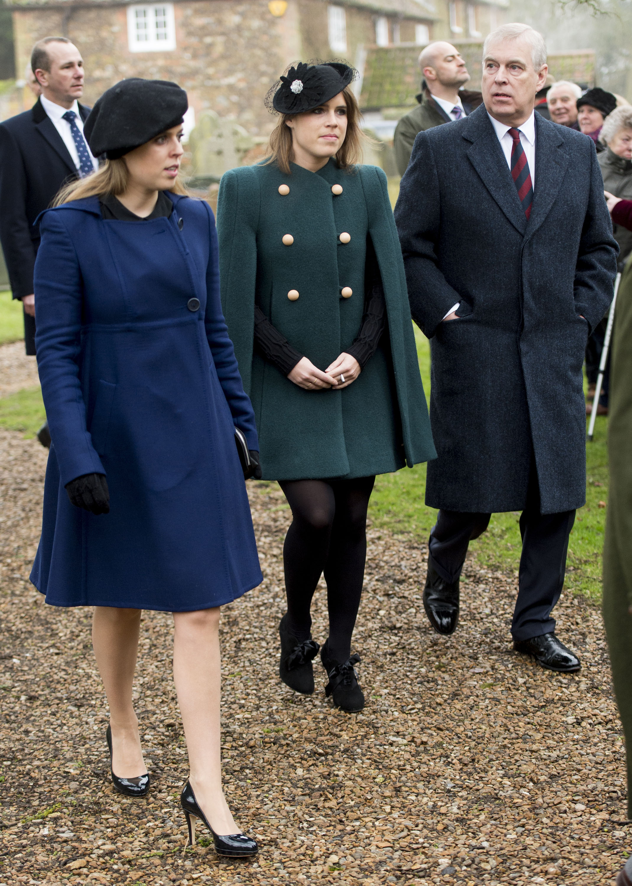 Princess Beatrice and Princess Eugenie walking to church in coats with Andrew Mountbatten-Windsor