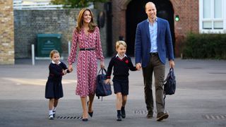 Princess Charlotte accompanied by her father, Britain's Prince William, her mother, Catherine, and brother, Britain's Prince George, arrives for her first day of school