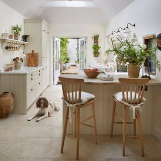 neutral vaulted cottage kitchen diner with breakfast stools