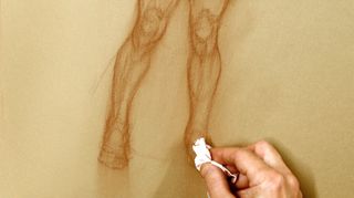 How to draw a figure: Artist rubbing paper with a tissue