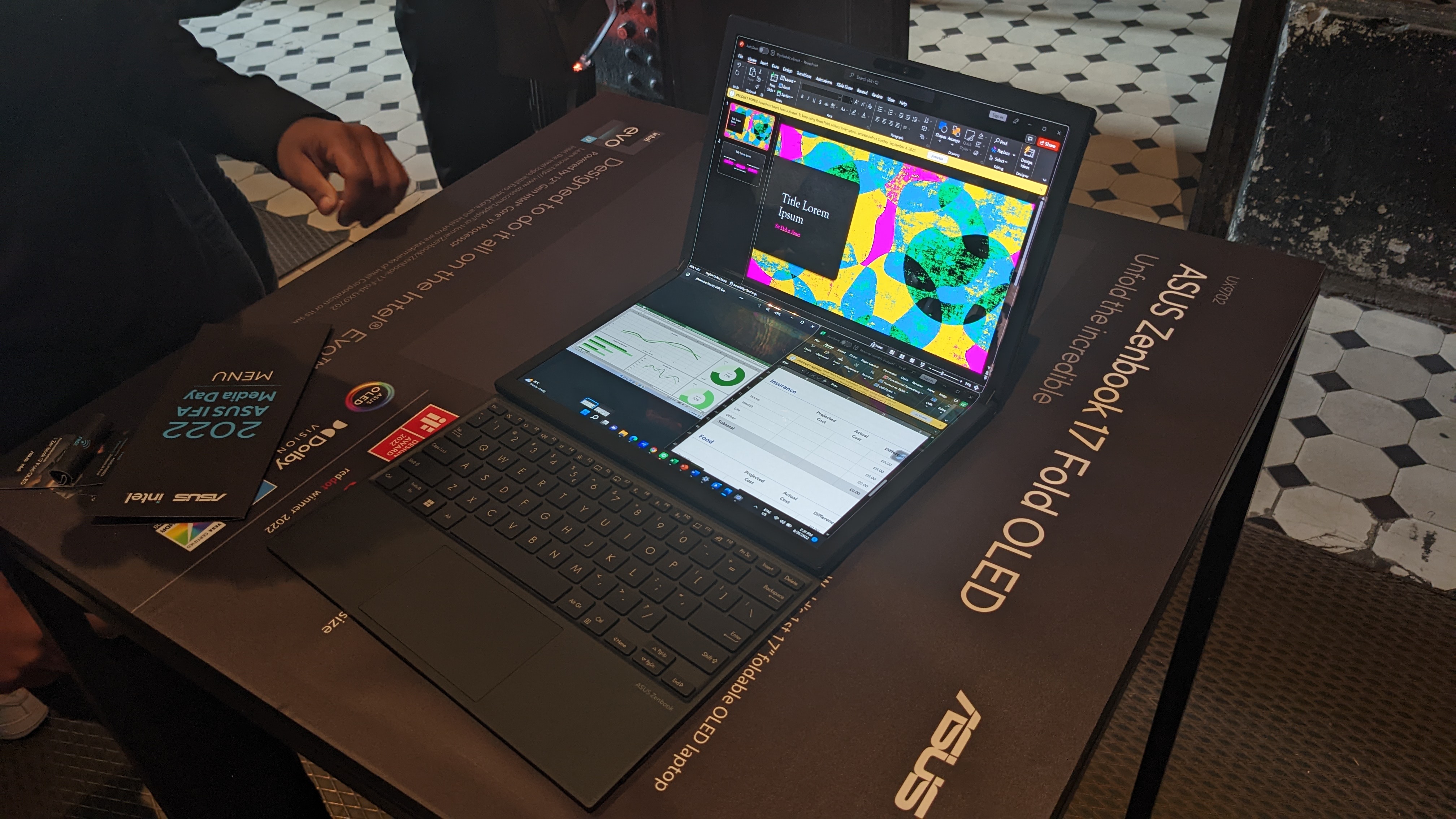 Asus Zenbook 17 Fold OLED foldable laptop on a desk at the Asus launch event.