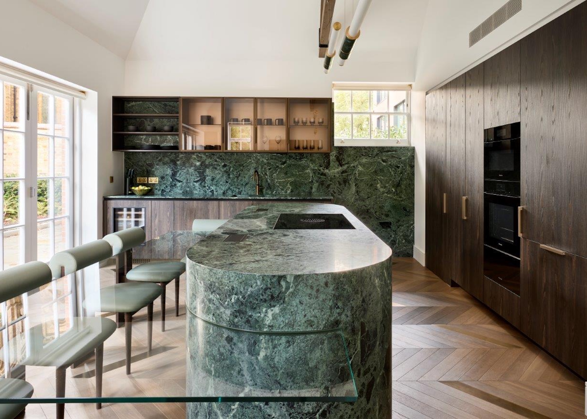 kitchen with green marble and dark wood cabinets