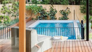 A backyard pool with greenery