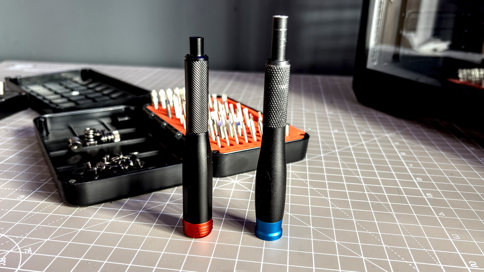 Two screwdrivers on a desk with orange highlights, sold by the YouTube channel Linus Tech Tips, or LTT for short.