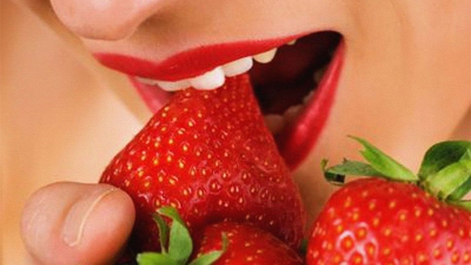 woman eating strawberries