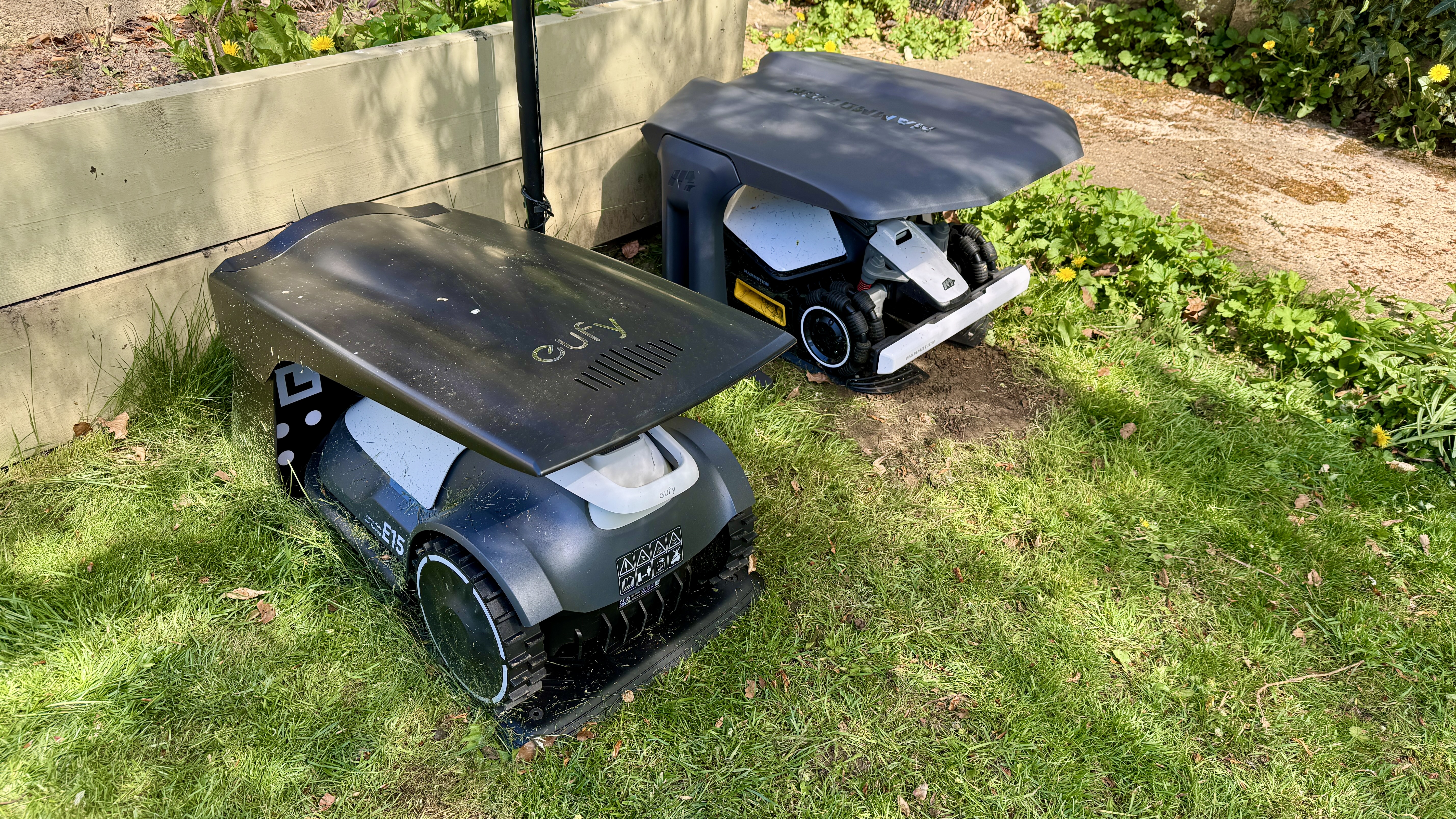 Two robot lawn mowers in their garages