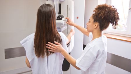 Female doctor and a female patient during a mammogram. 