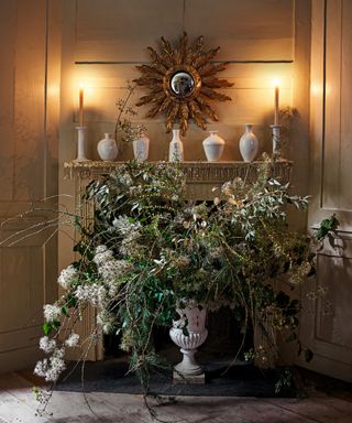 Quiet luxury Christmas decor with candles on mantle and ever green display