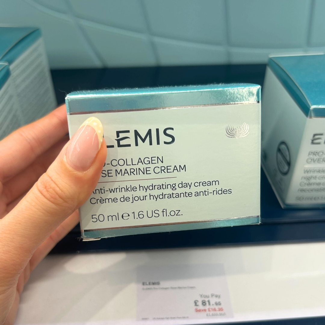 Hand holding box of Elemis Pro-Collagen Marine Cream SPF30 in World Duty Free