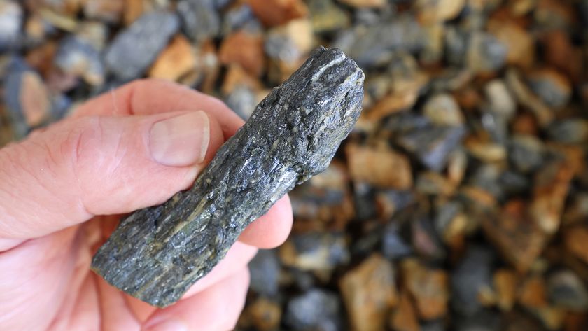 A person holding a piece of antimony