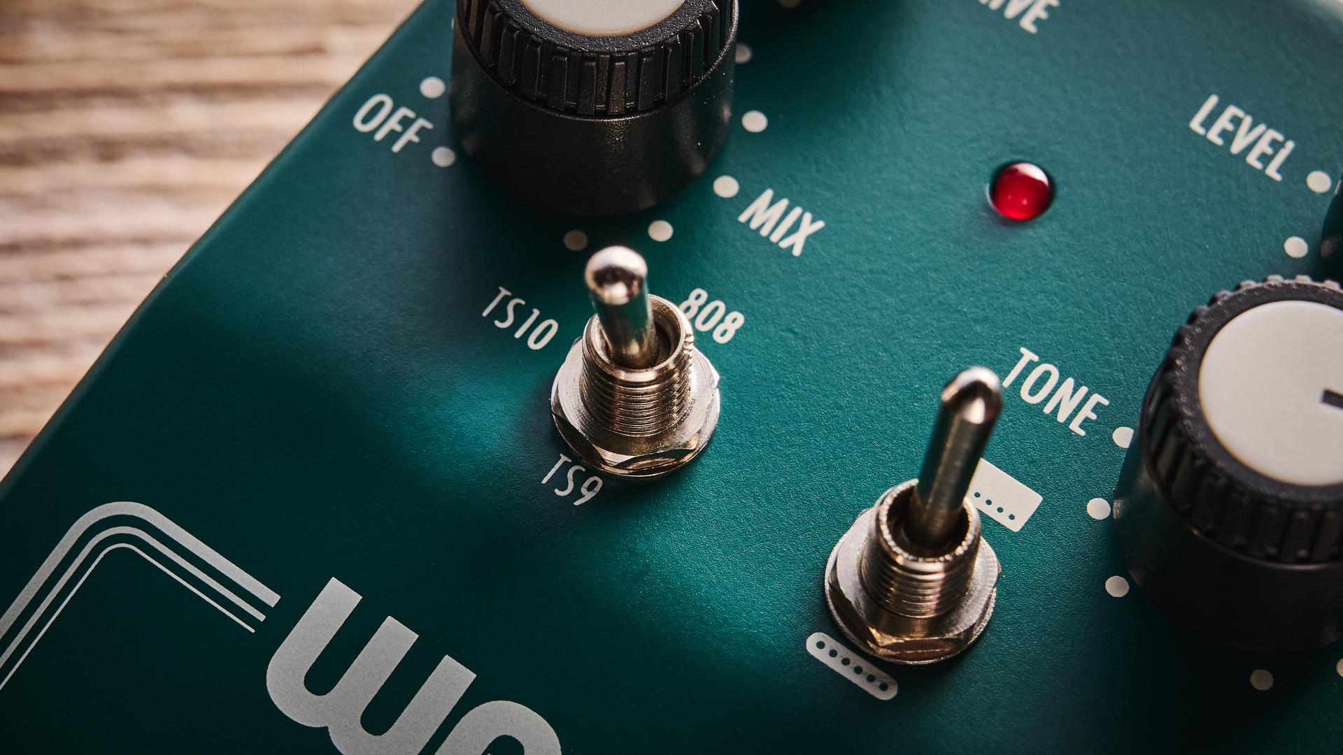 Warm Audio Tube Squealer green overdrive pedal shot on wood floorboards