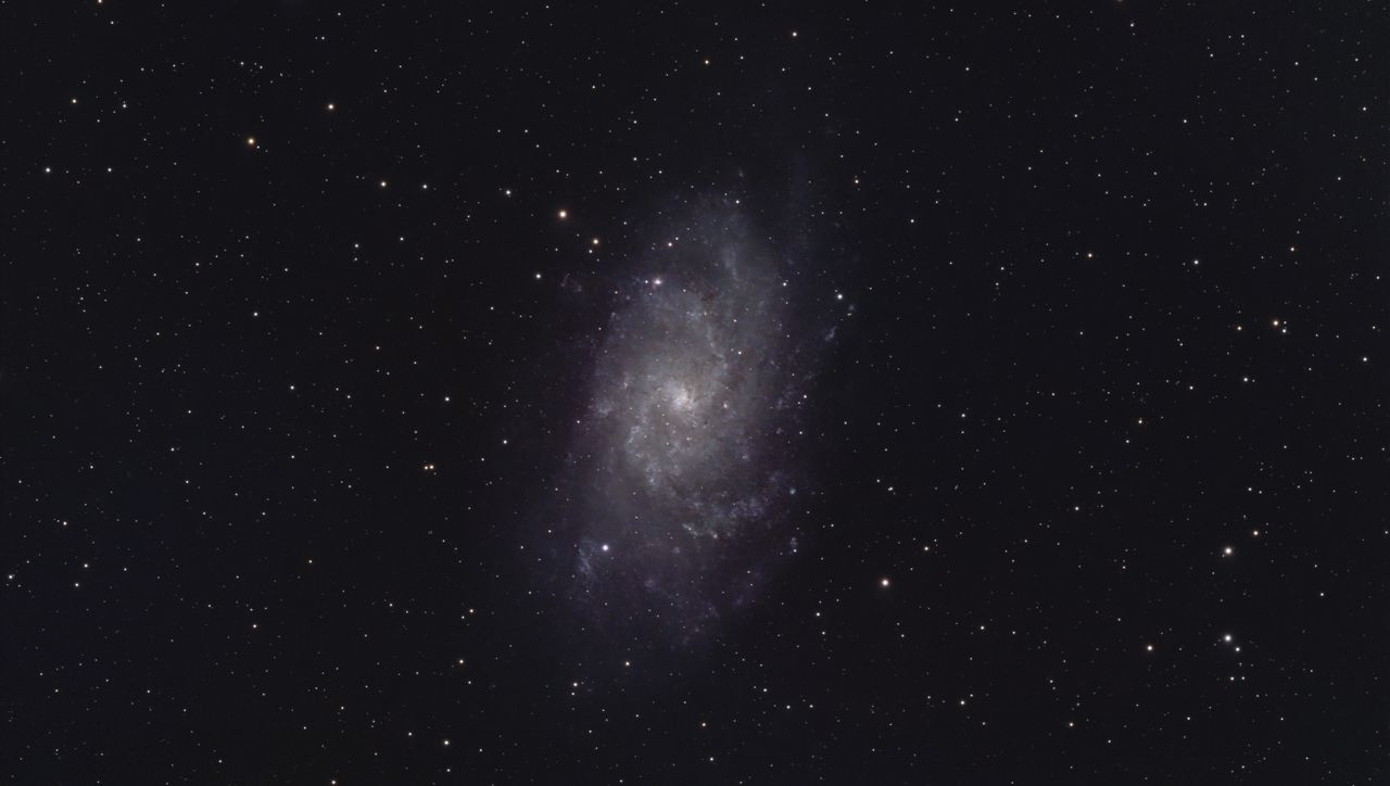 A photograph of the M33 galaxy in Triangulum, taken with the Dwarf III smart telescope, processed in Pixinsight