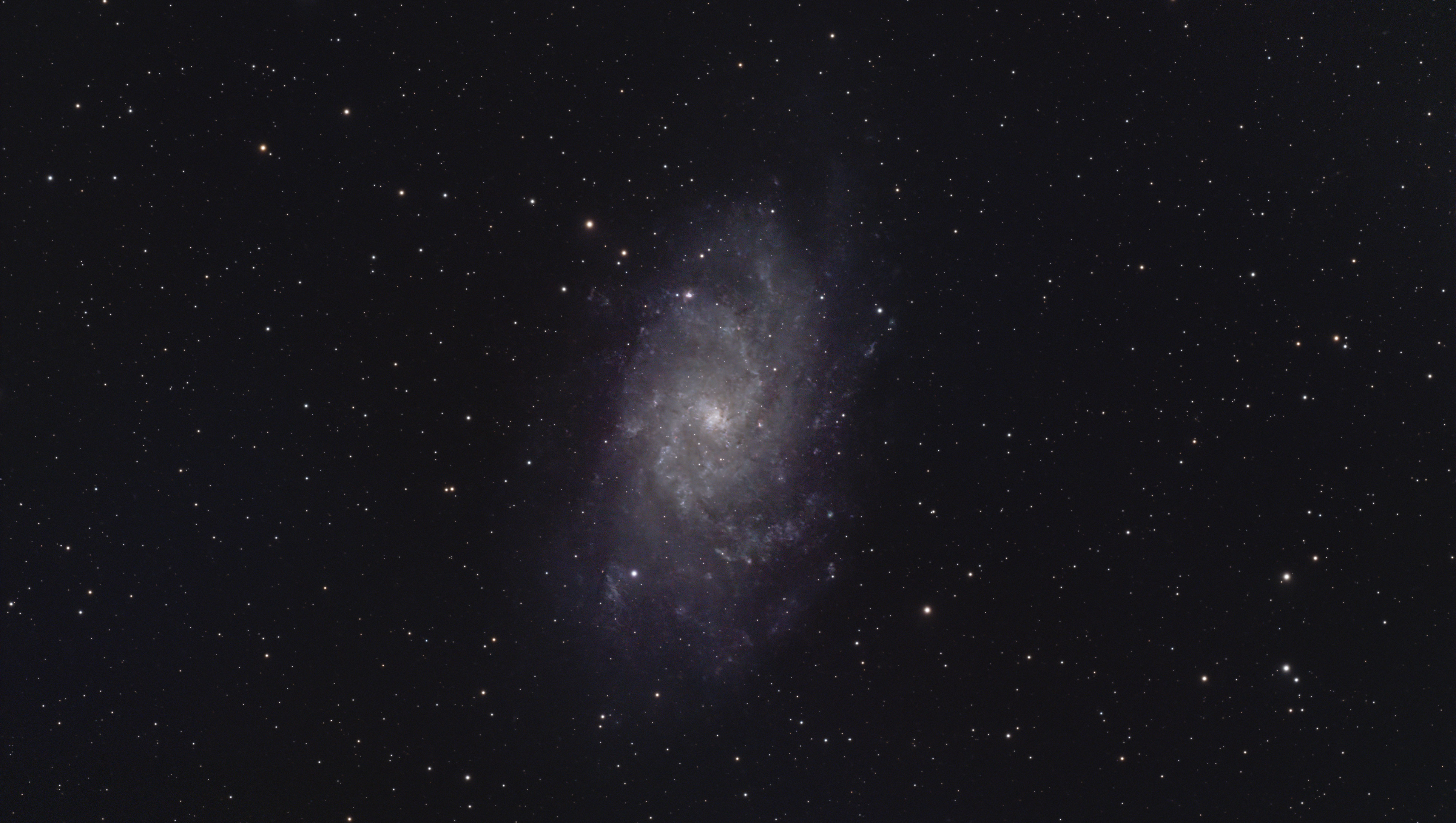 A photograph of the M33 galaxy in Triangulum, taken with the Dwarf III smart telescope, processed in Pixinsight