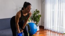 Woman training with kettlebell at home