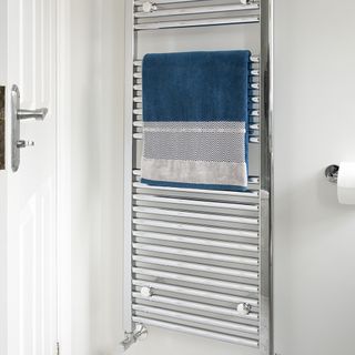 bathroom and towel rack with white door