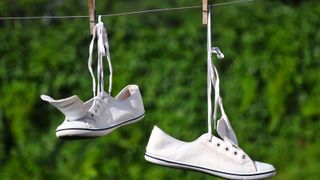 white sneakers drying on a clothes line