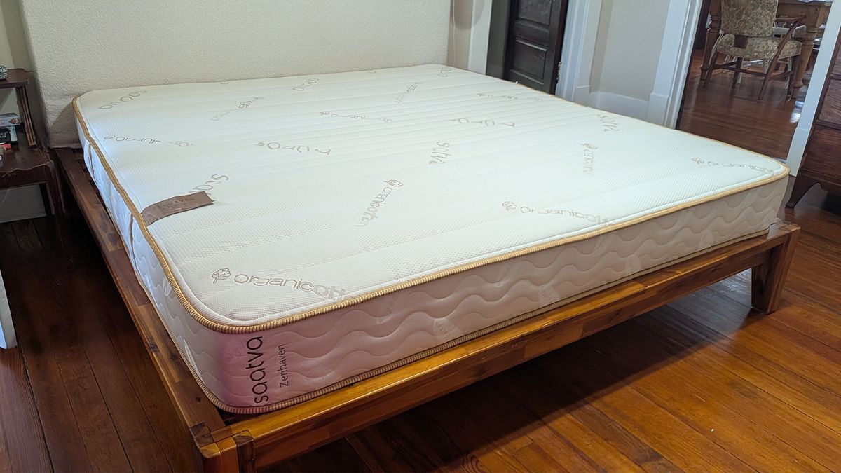 The Saatva Zenhaven Latex Mattress on a bed frame in our tester's bedroom