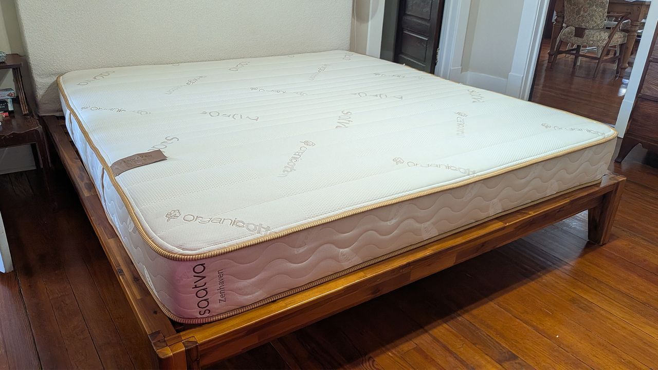 The Saatva Zenhaven Latex Mattress on a bed frame in our tester's bedroom