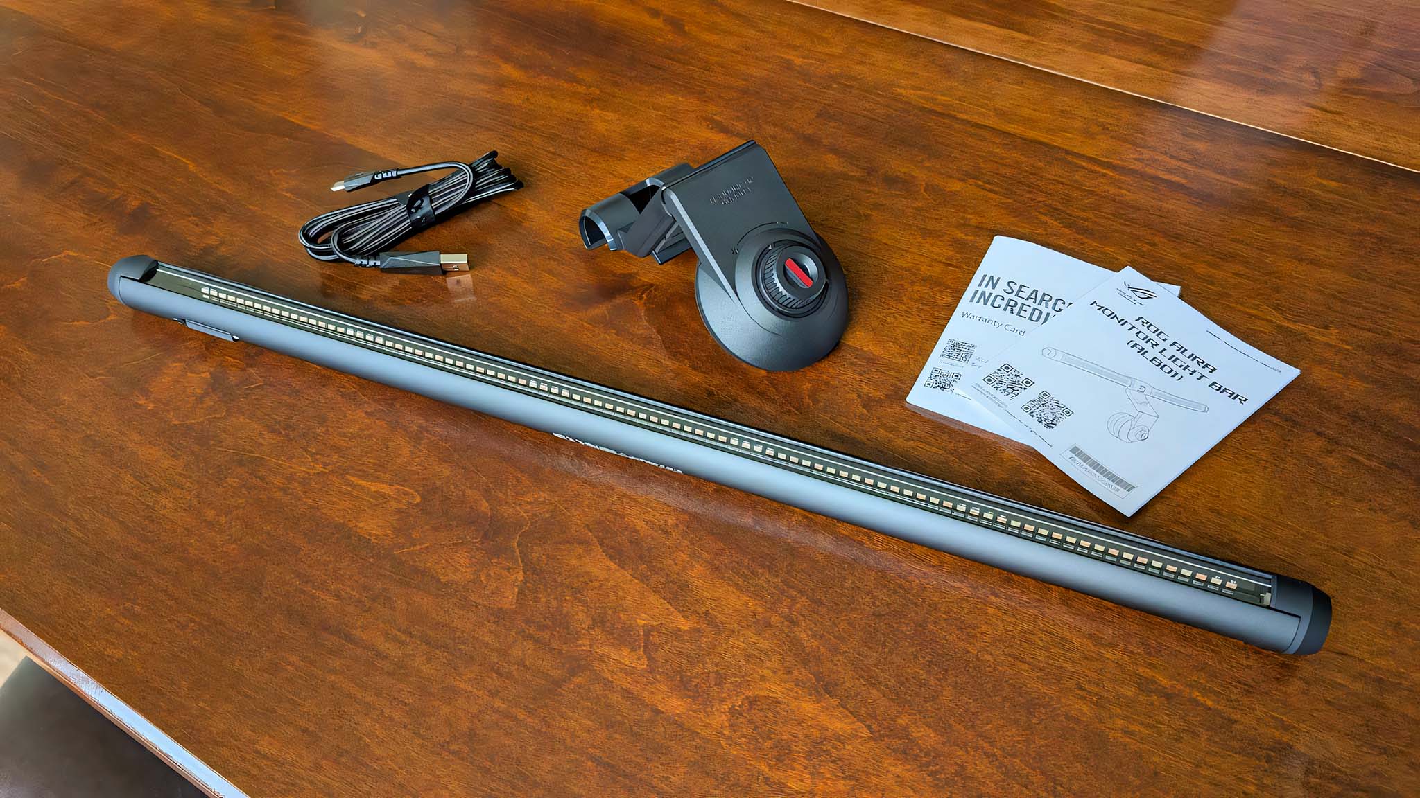 ASUS ROG Aura Monitor Light Bar with USb-C cable, back attachment, and manuals.