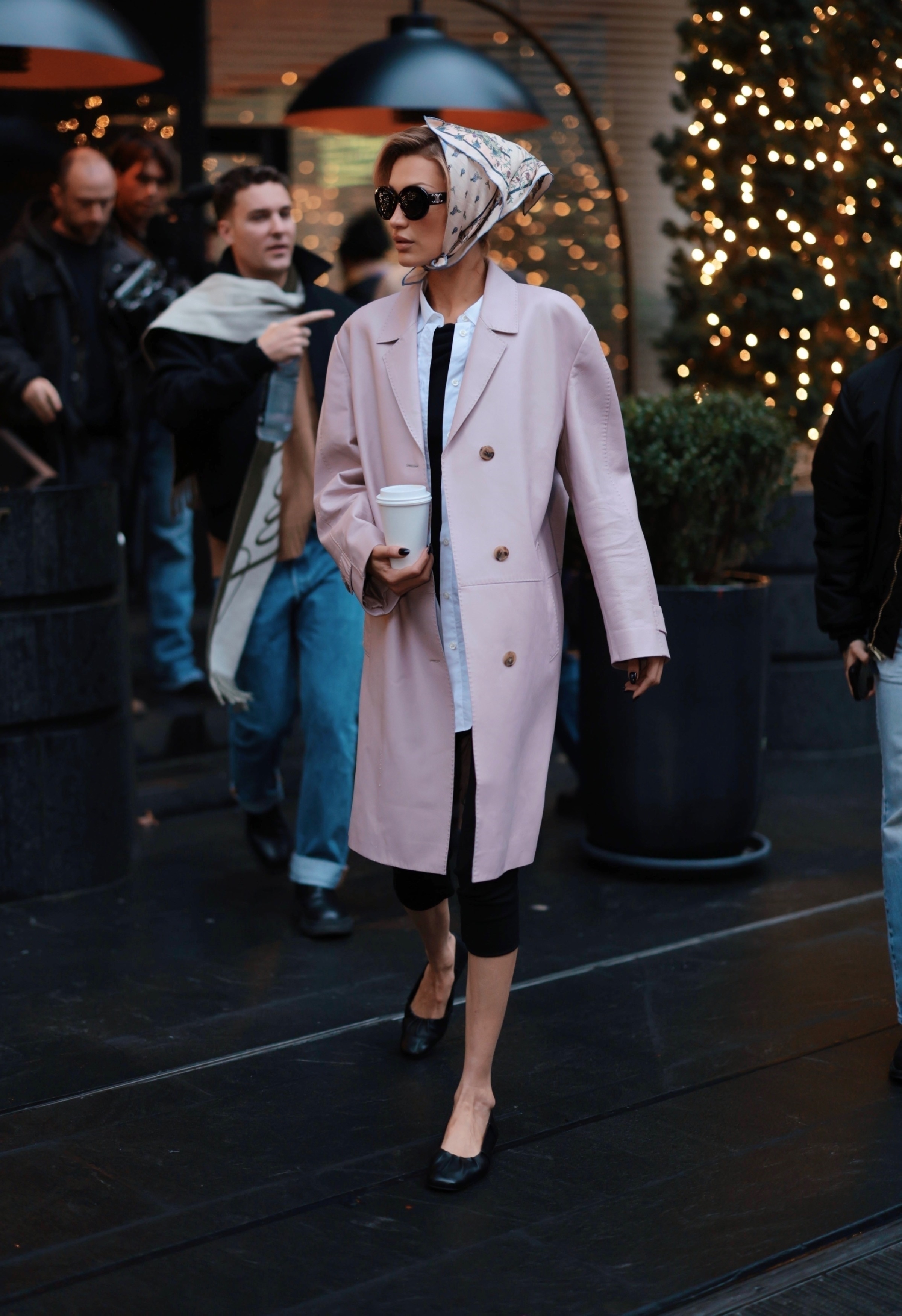 Bella Hadid was spotted in New York wearing a winter take on the capri trend, a pale pink coat, and a silk hair scarf