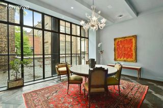 A traditional style dining room with floor to ceiling windows