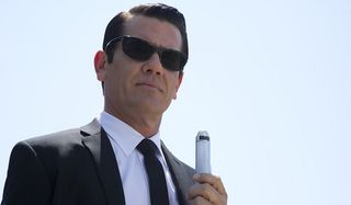 Men in Black III Josh Brolin Agent K stands with a classic neurolyzer in 1969