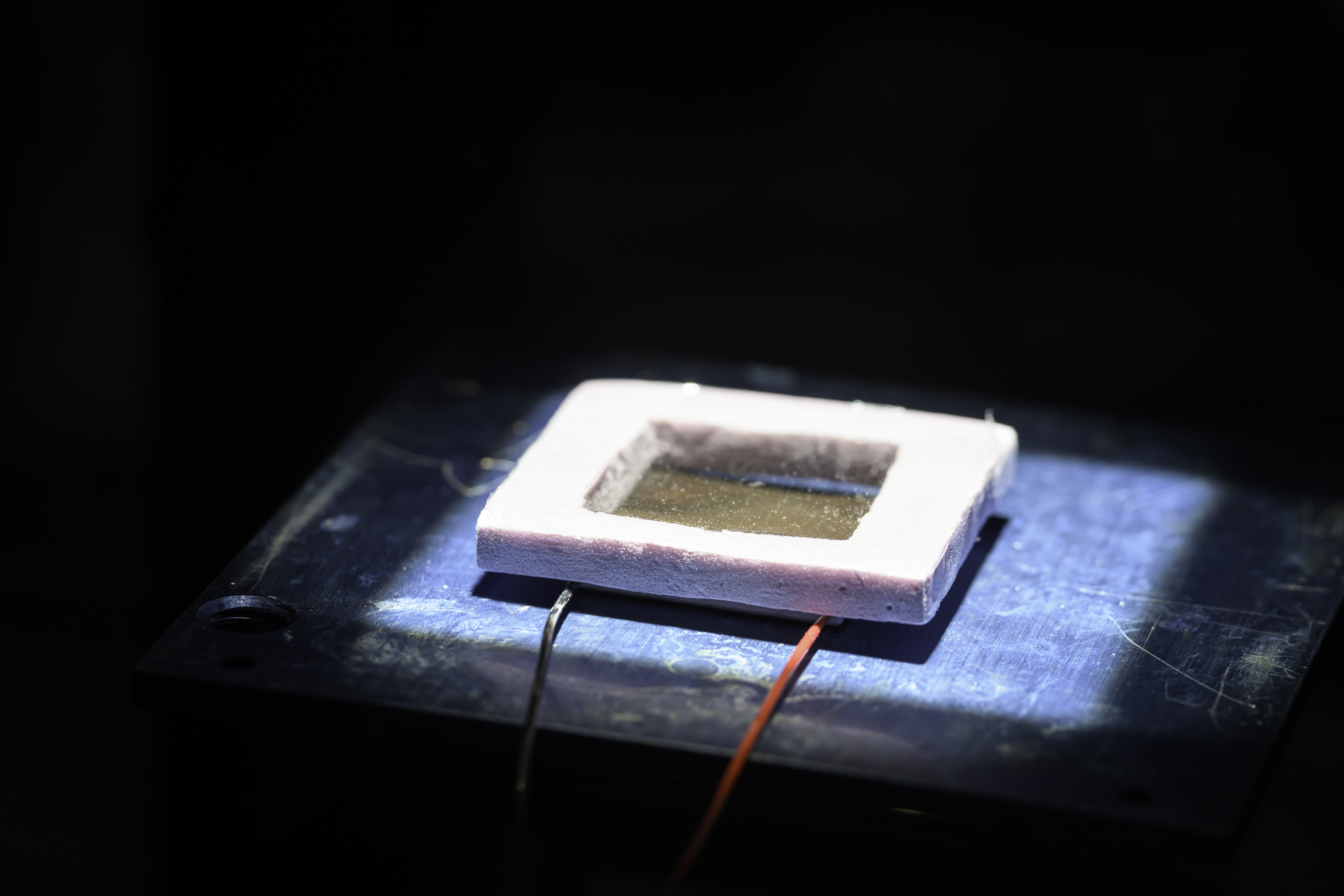 A rectangular technology device covered in a piece of plastic.