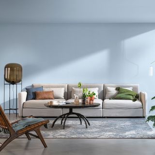 Light blue living room with a light grey sofa and wooden coffee table