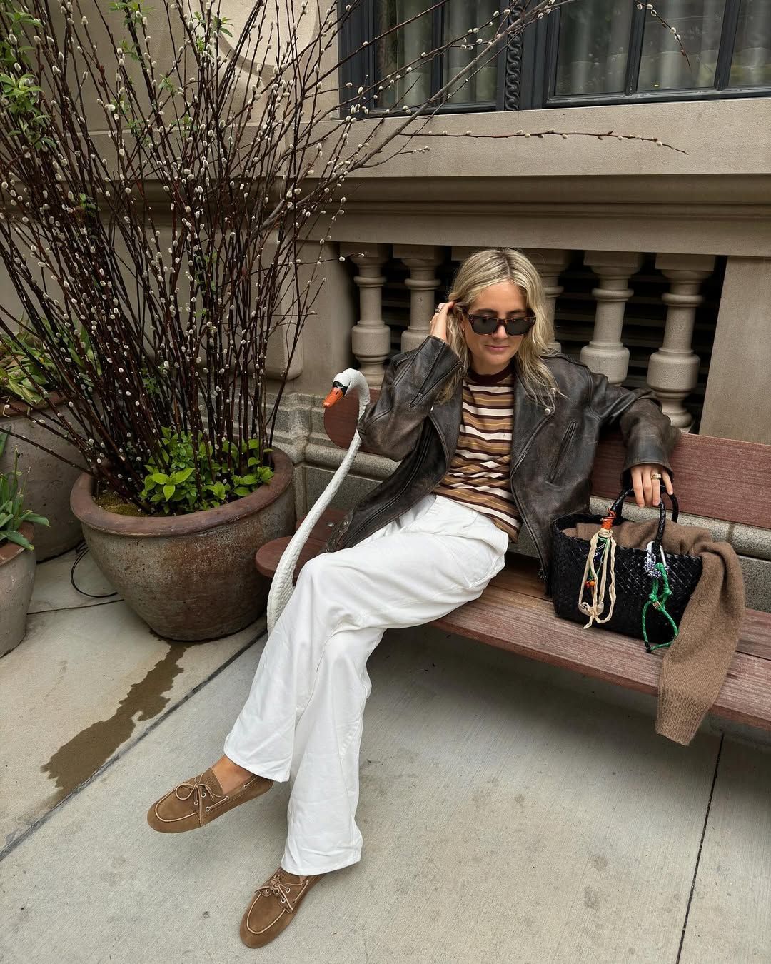 Lucy Williams in a striped T-shirt, white jeans, and boat shoes.