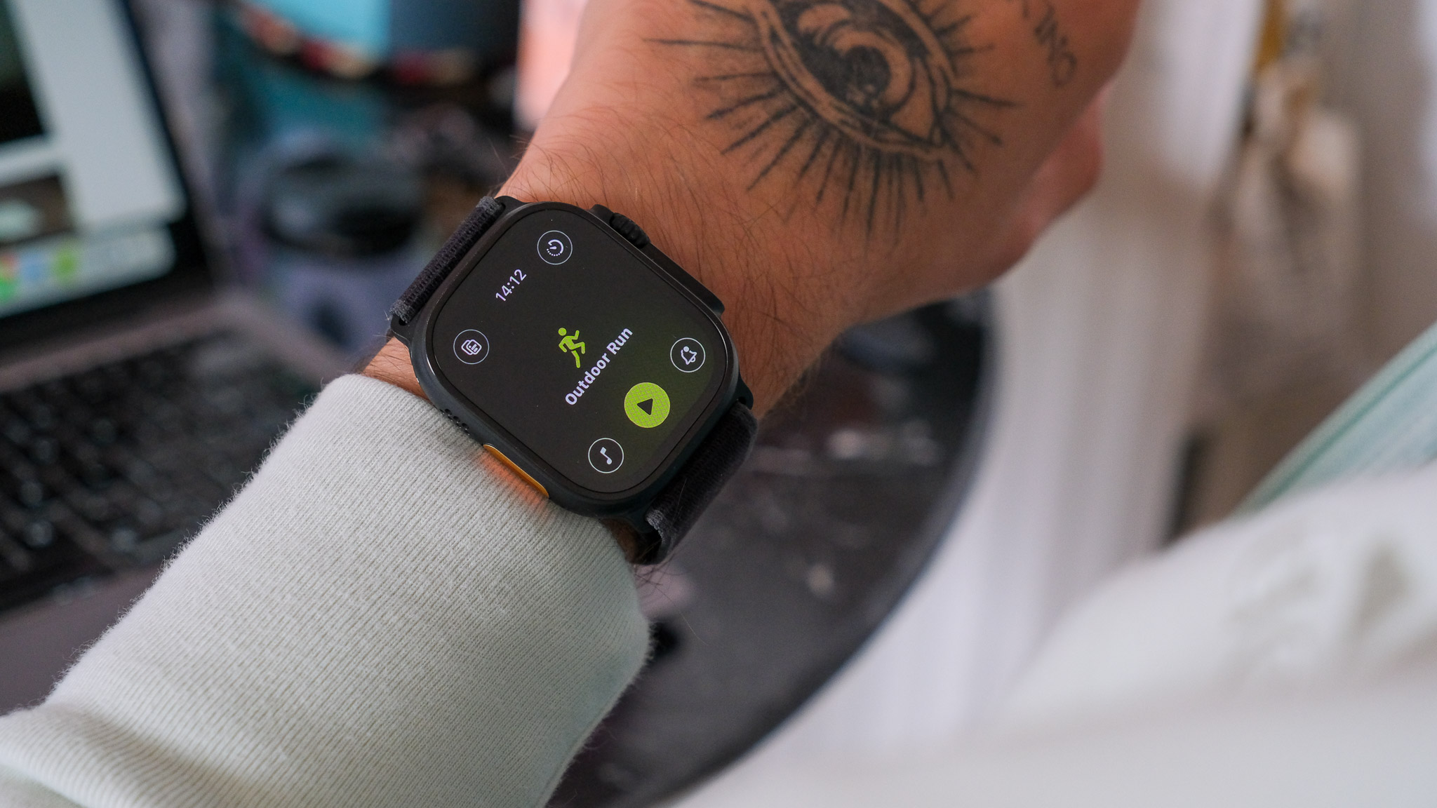 Black Apple Watch Ultra 2 displaying watchOS 26
