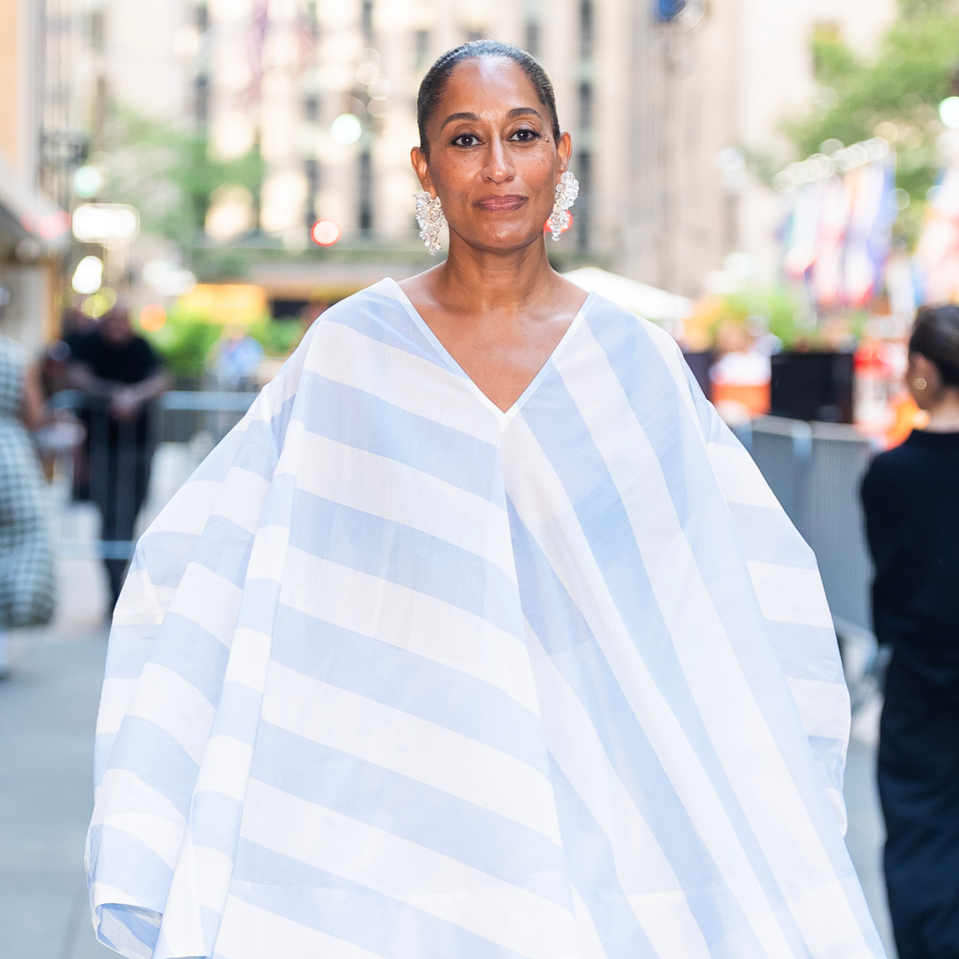 Tracee Ellis Ross wearing a flowy blue and white short. She has her hair in a slicked back bun. 