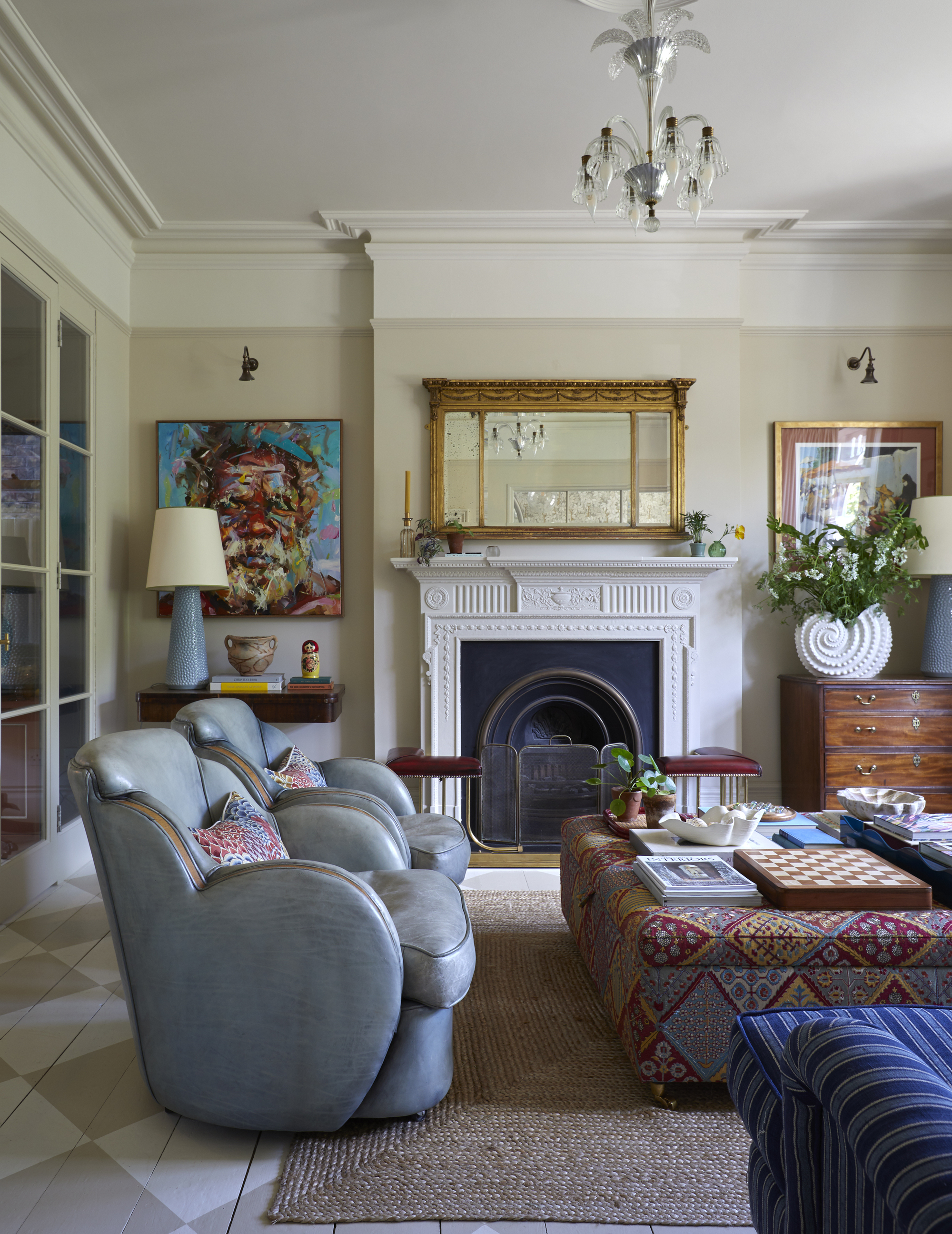 a traditional style living room with a fireplace and ceiling pendant