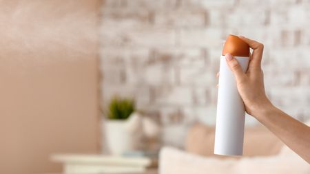 White can of air freshener being sprayed