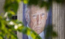 A banner showing a picture of President Donald Trump is displayed outside of the U.S. Department of Agriculture building is seen through trees on the National Mall on June 3, 2025 in Washington, DC. 