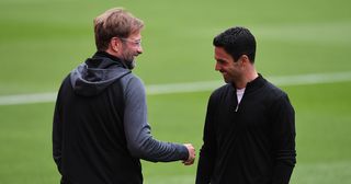 Liverpool and Arsenal managers Mikel Arteta and Jurgen Klopp share a moment before the Premier League match between Arsenal FC and Liverpool FC at Emirates Stadium on July 15, 2020 in London, England. Football Stadiums around Europe remain empty due to the Coronavirus Pandemic as Government social distancing laws prohibit fans inside venues resulting in all fixtures being played behind closed doors.