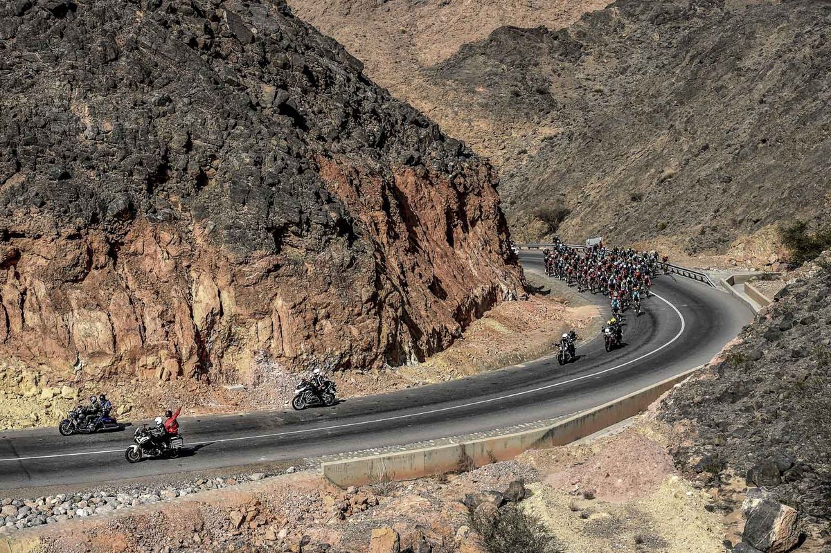 The peleton in the final 10km of the race navigating 'The Climb of Wadi Dayqah' as the temperatures begin to rise.
