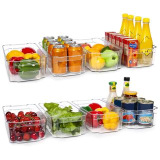 Clear plastic fridge organizers filled with fresh and canned groceries