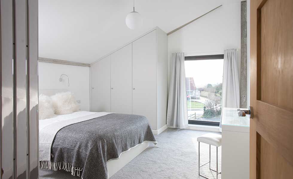 built in wardrobes beneath vaulted ceiling