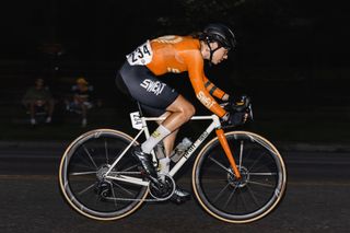 Hunt Limitless 48 UD Carbon Spokes ridden on a white bike in a nighttime criterium