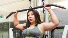 Woman doing lateral pulldowns in gym