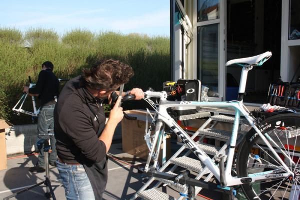A team mechanic files down part of the bars