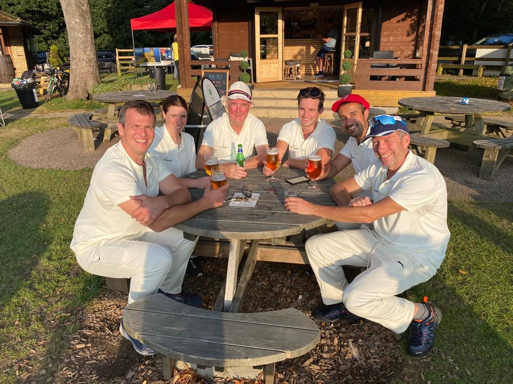 The vets have a pint wearing cricket gear.